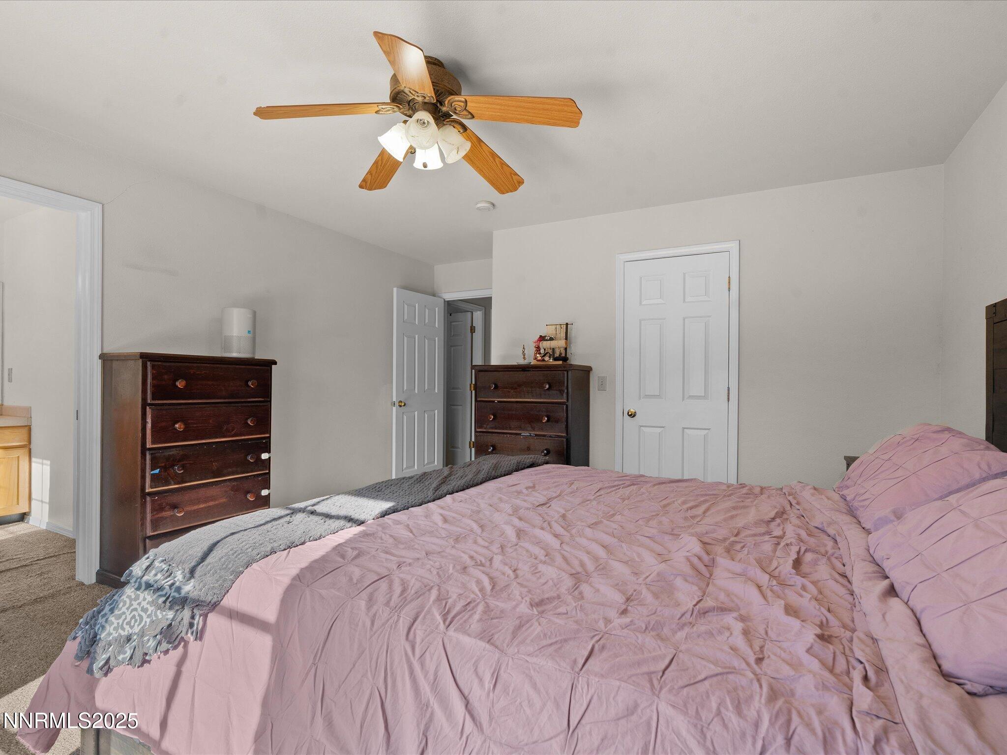 1819 Bogie Court Fernley, NV 89408 - Photo 20 of 46 a bedroom with a bed and a chandelier