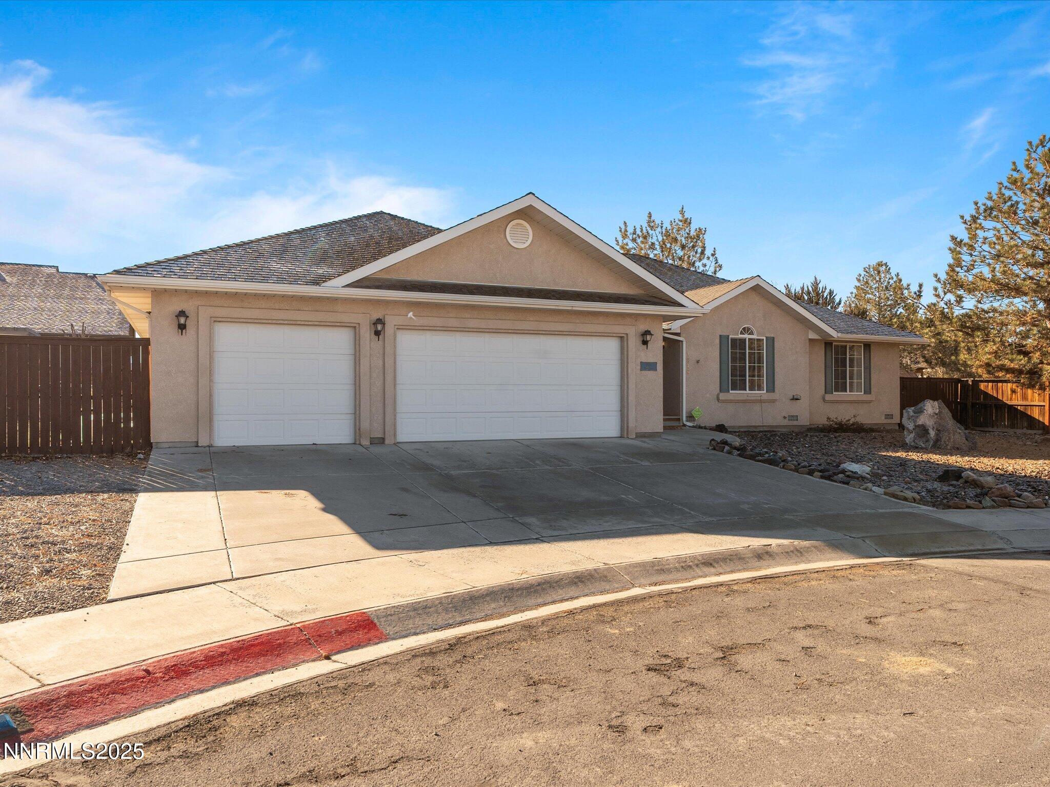 1819 Bogie Court Fernley, NV 89408 - Photo 2 of 46 a front view of a house with a yard and garage