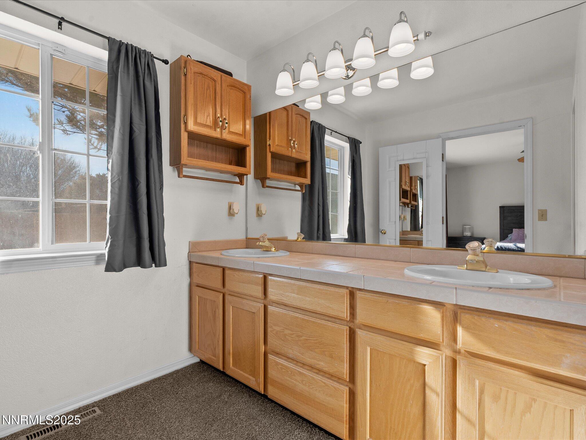 1819 Bogie Court Fernley, NV 89408 - Photo 23 of 46 a bathroom with a double vanity sink and a mirror