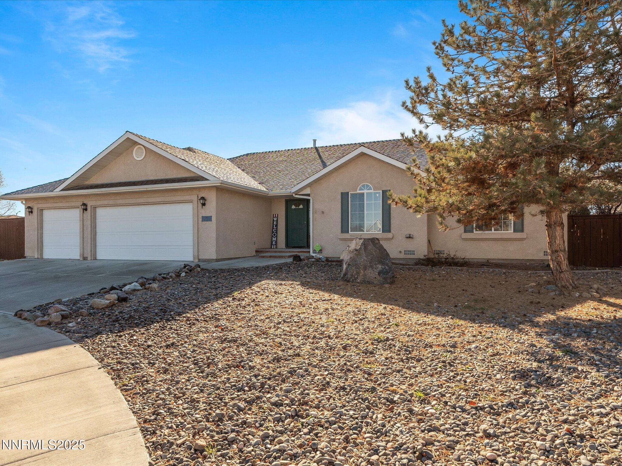 1819 Bogie Court Fernley, NV 89408 - Photo 3 of 46 a front view of a house with a yard