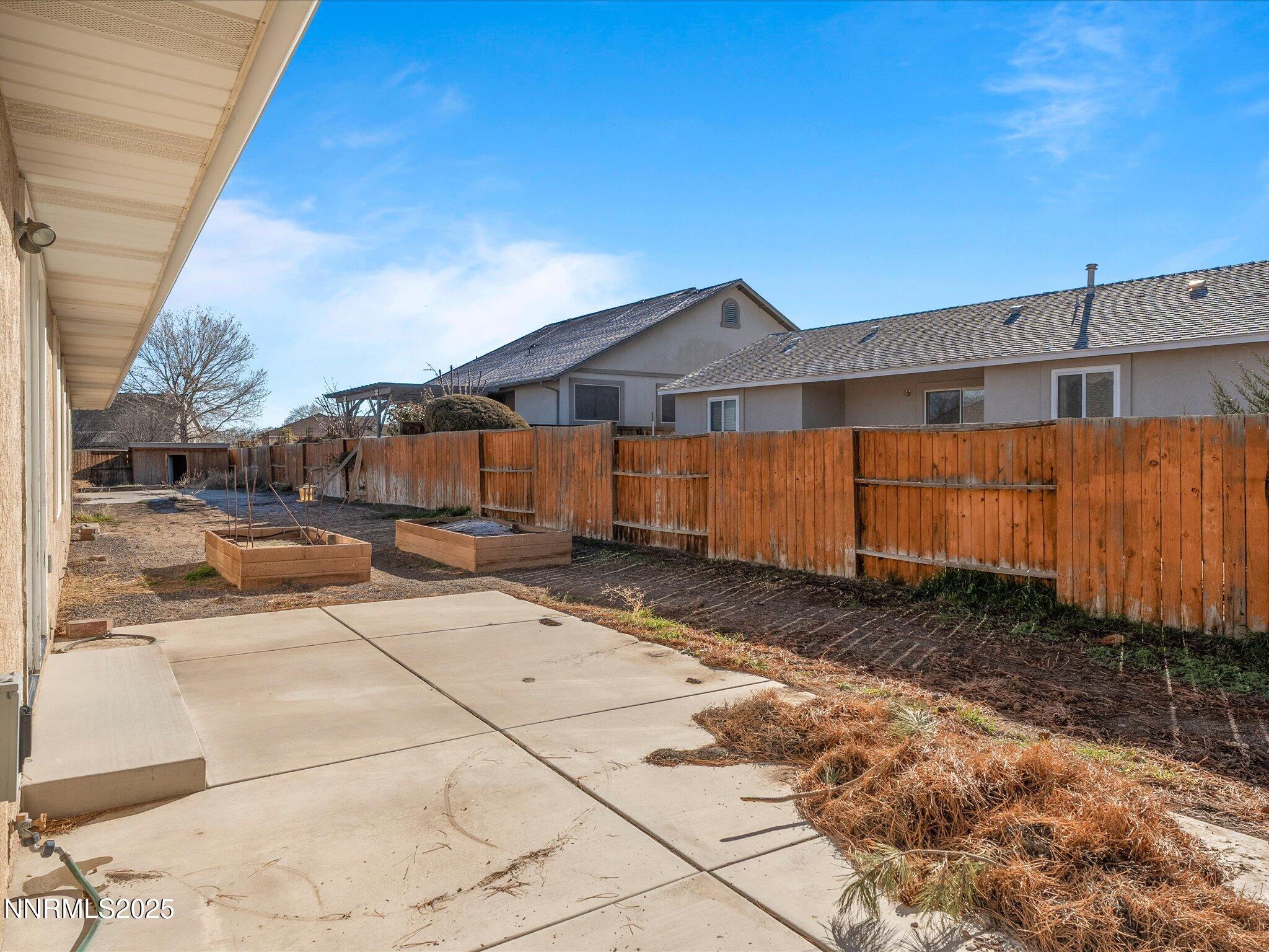 1819 Bogie Court Fernley, NV 89408 - Photo 31 of 46 a view of a house with backyard and wooden fence