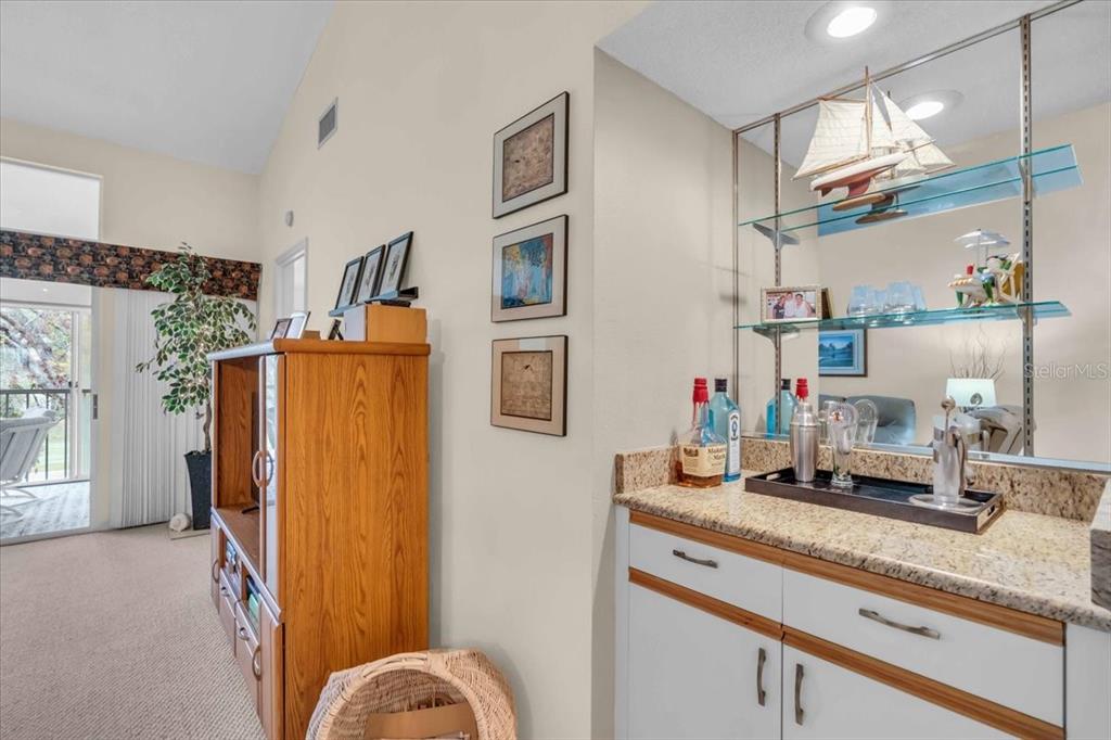 6713 Stone River Road, Unit 206 Bradenton, FL 34203 - Photo 12 of 58 a bathroom with a granite countertop sink and a mirror