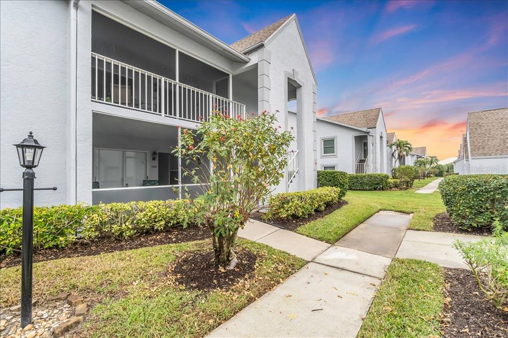 6713 Stone River Road, Unit 206 Bradenton, FL 34203 - Photo 2 of 58 a front view of a house with garden
