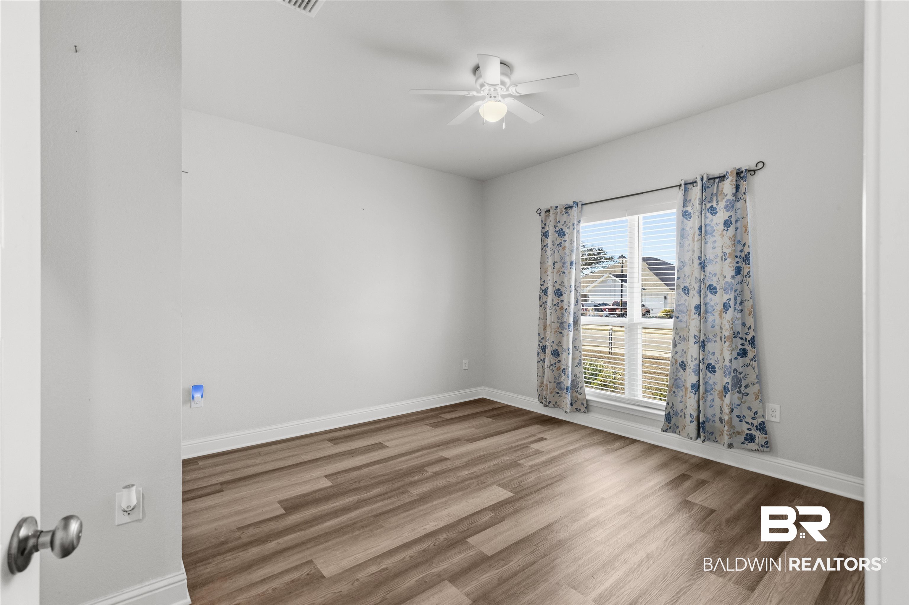 485 Shepard Street Gulf Shores, AL 36542 - Photo 31 of 53 Spare bedroom featuring wood finished floors and a ceiling fan