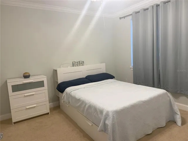 a bedroom with a bed and a dresser