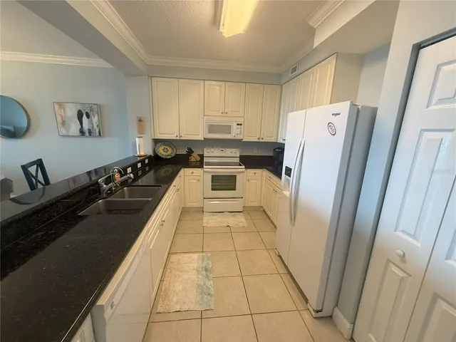 a kitchen with stainless steel appliances a refrigerator and a stove