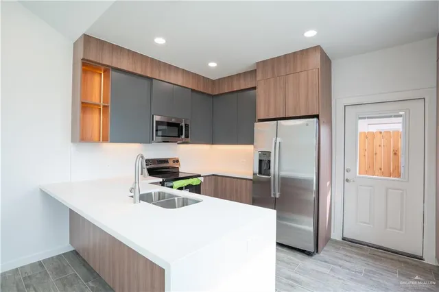 a kitchen with refrigerator and microwave