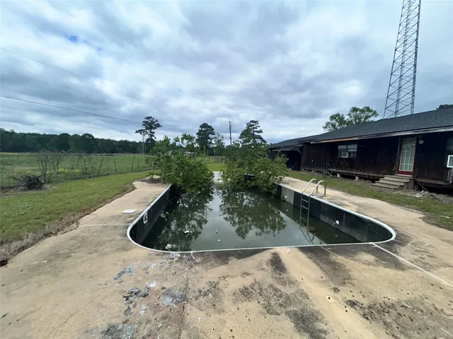 a view of a swimming pool with a yard
