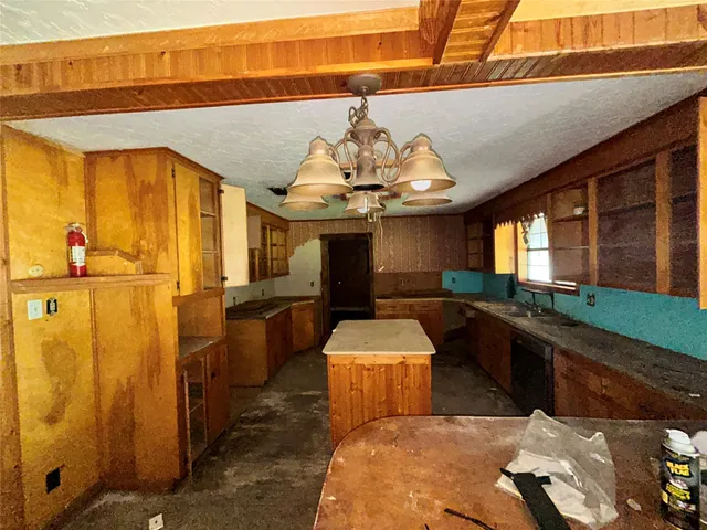 a kitchen with stainless steel appliances kitchen island granite countertop a sink and cabinets