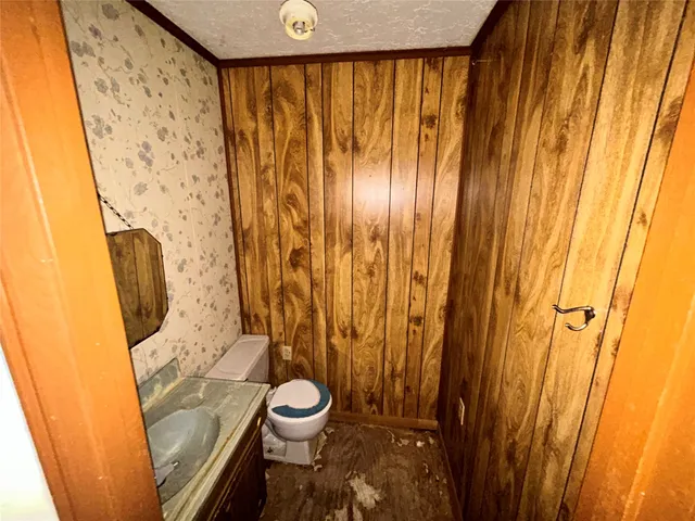 a bathroom with a granite countertop shower a sink and a mirror