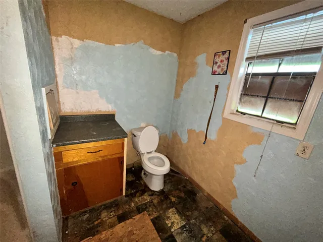 a bathroom with a sink a toilet a mirror and shower