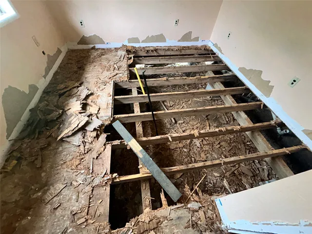 a view of a room with wooden floor