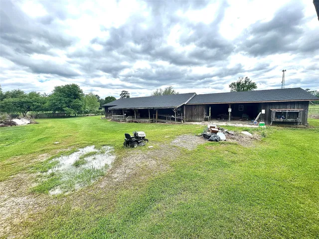 a view of a house with swimming pool and a yard