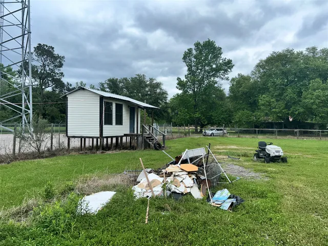 a view of a house with backyard and sitting area