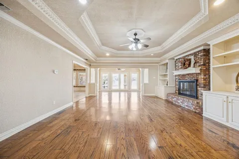 a view of livingroom with kitchen and fireplace