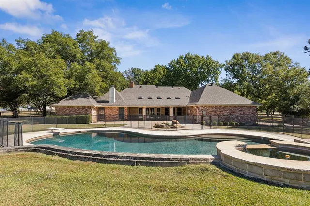 a front view of house with yard and outdoor seating