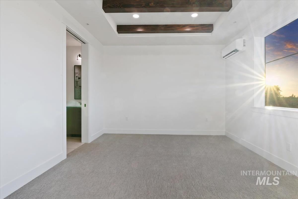 3249 West Moore Street Boise, ID 83702 - Photo 15 of 35 Spare room with a raised ceiling, a wall unit AC, and light colored carpet