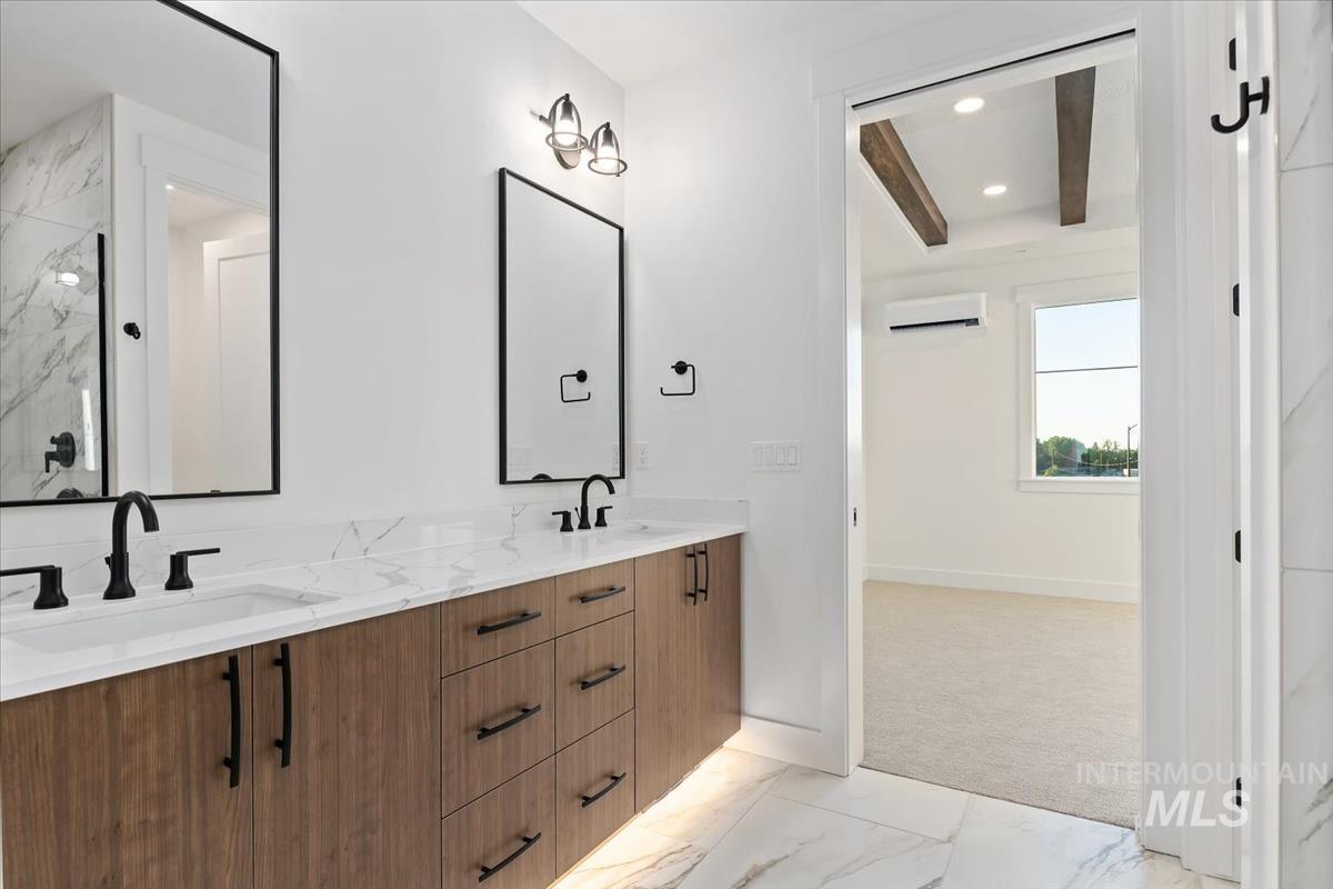 3249 West Moore Street Boise, ID 83702 - Photo 16 of 35 Bathroom featuring light marble finish flooring, double vanity, recessed lighting, an AC wall unit, and a marble finish shower