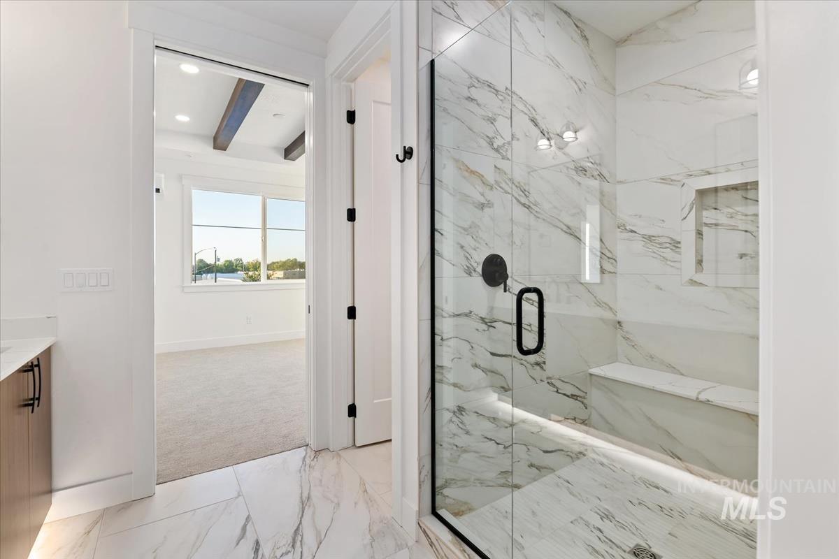 3249 West Moore Street Boise, ID 83702 - Photo 17 of 35 Bathroom featuring light marble finish floors, vanity, beam ceiling, a marble finish shower, and recessed lighting