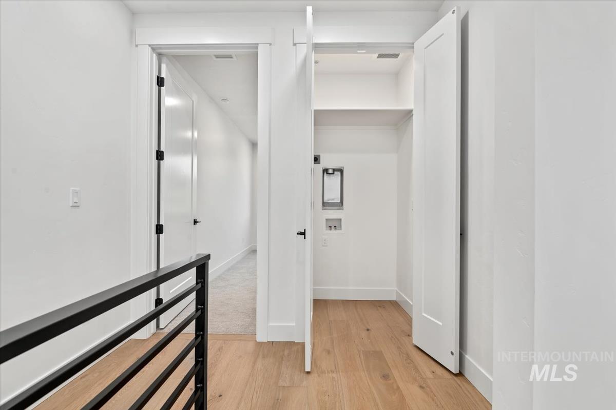 3249 West Moore Street Boise, ID 83702 - Photo 19 of 35 Hall with light wood-style floors and baseboards