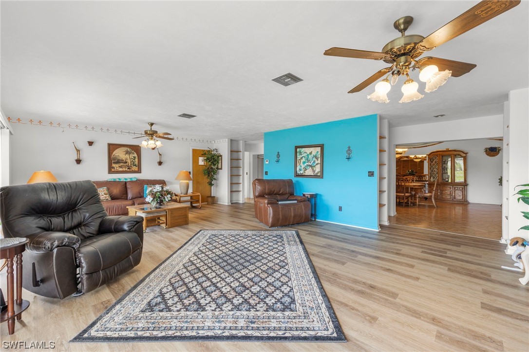 13751 River Road Fort Myers, FL 33905 - Photo 12 of 50 a living room with furniture a rug and a chandelier