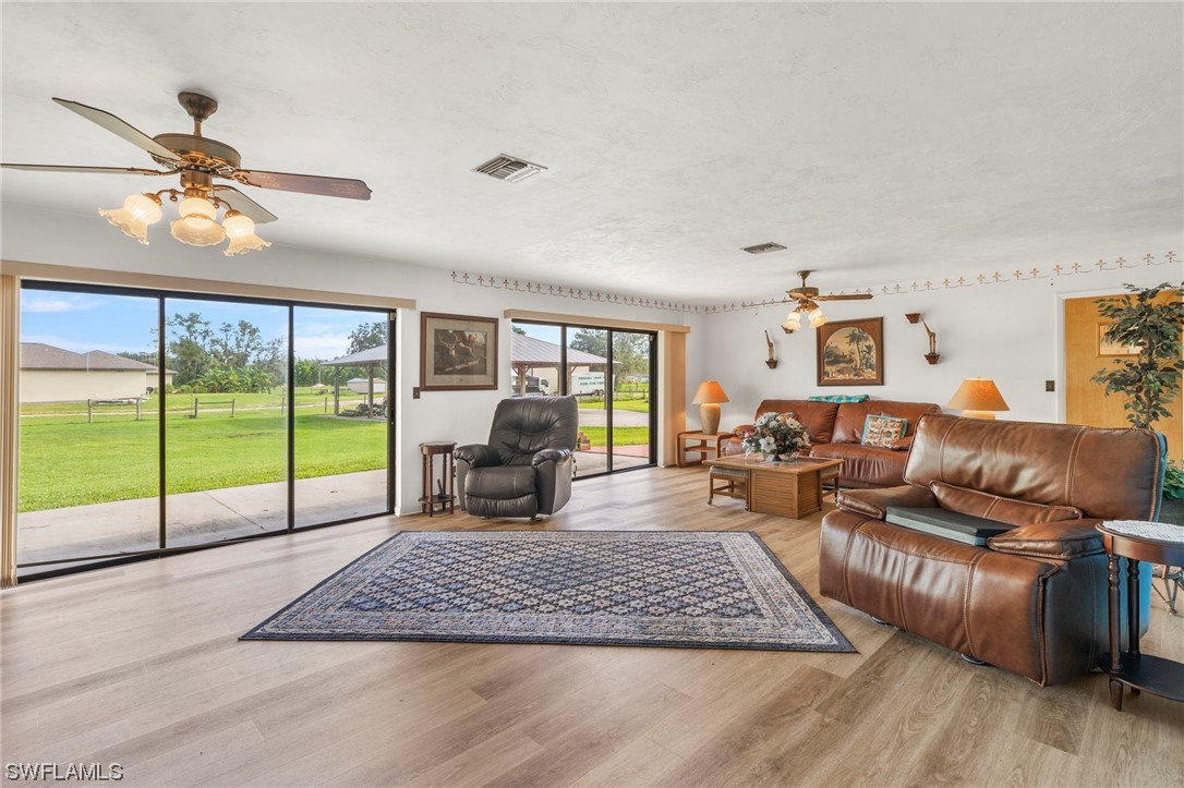 13751 River Road Fort Myers, FL 33905 - Photo 13 of 50 a living room with furniture floor to ceiling window and a flat screen tv