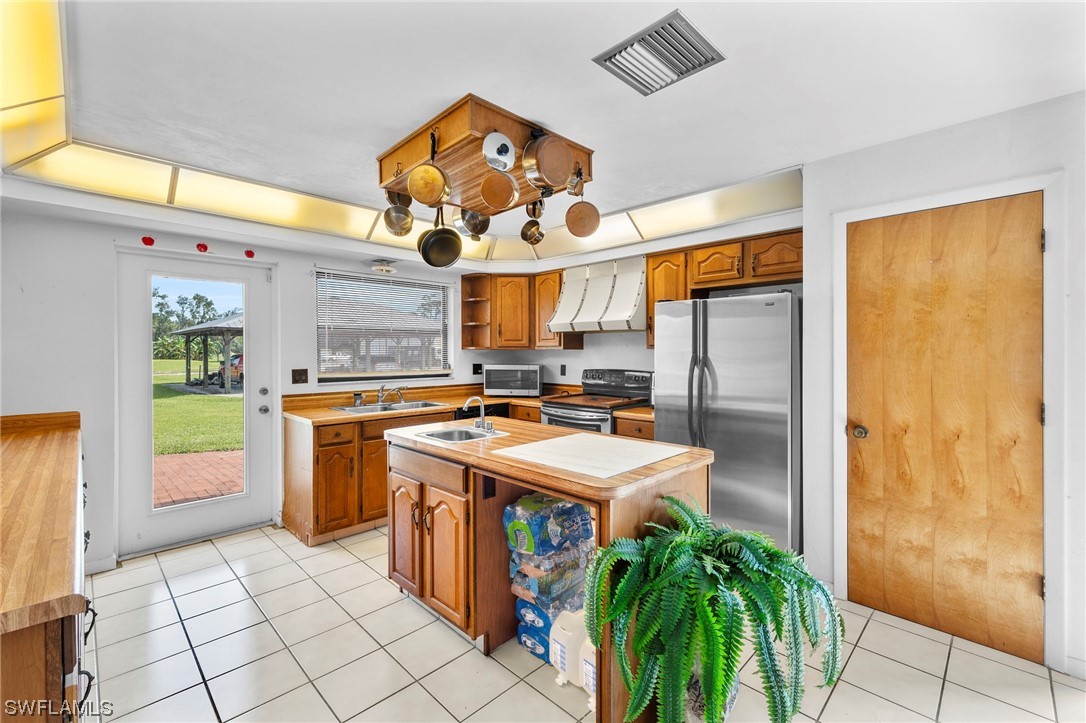 13751 River Road Fort Myers, FL 33905 - Photo 19 of 50 a kitchen with stainless steel appliances granite countertop a stove a sink and a refrigerator