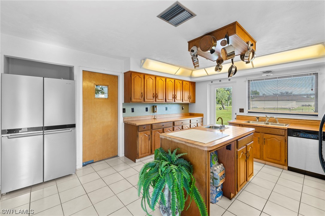 13751 River Road Fort Myers, FL 33905 - Photo 20 of 50 a kitchen with a sink a refrigerator and a stove