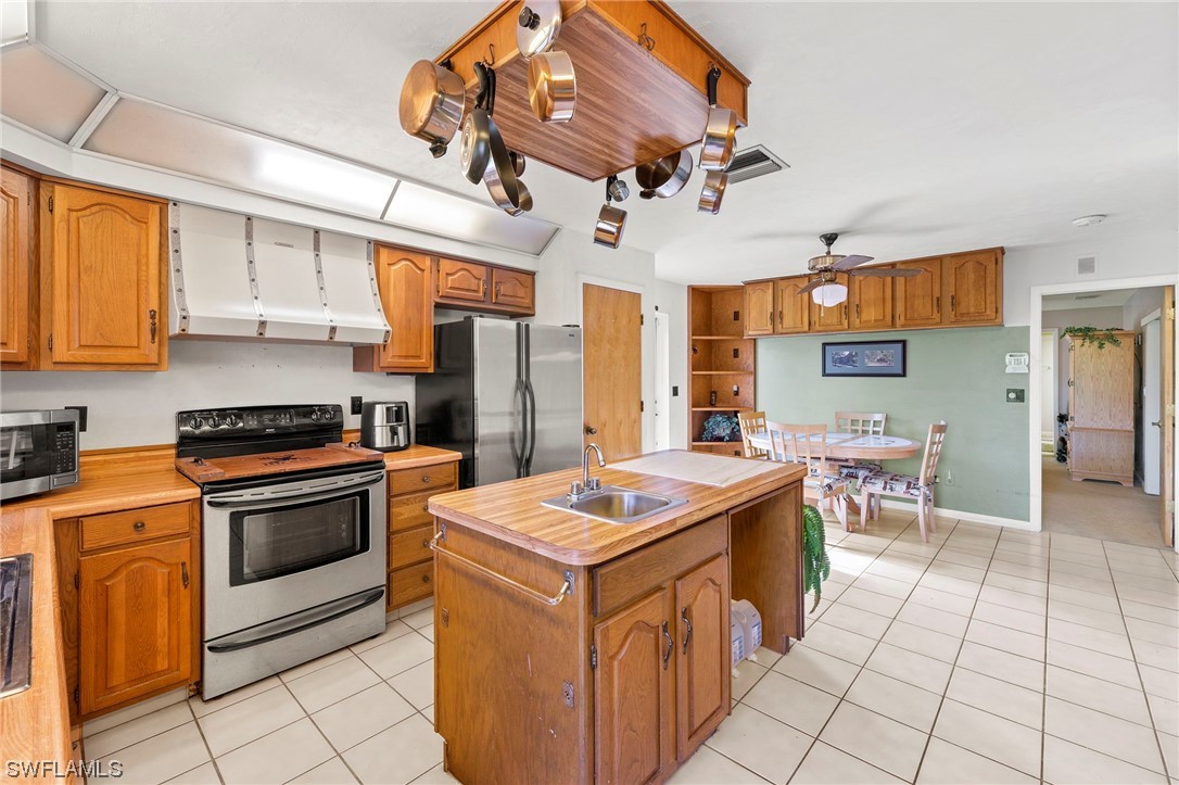 13751 River Road Fort Myers, FL 33905 - Photo 21 of 50 a kitchen with stainless steel appliances granite countertop a stove a sink dishwasher and a refrigerator