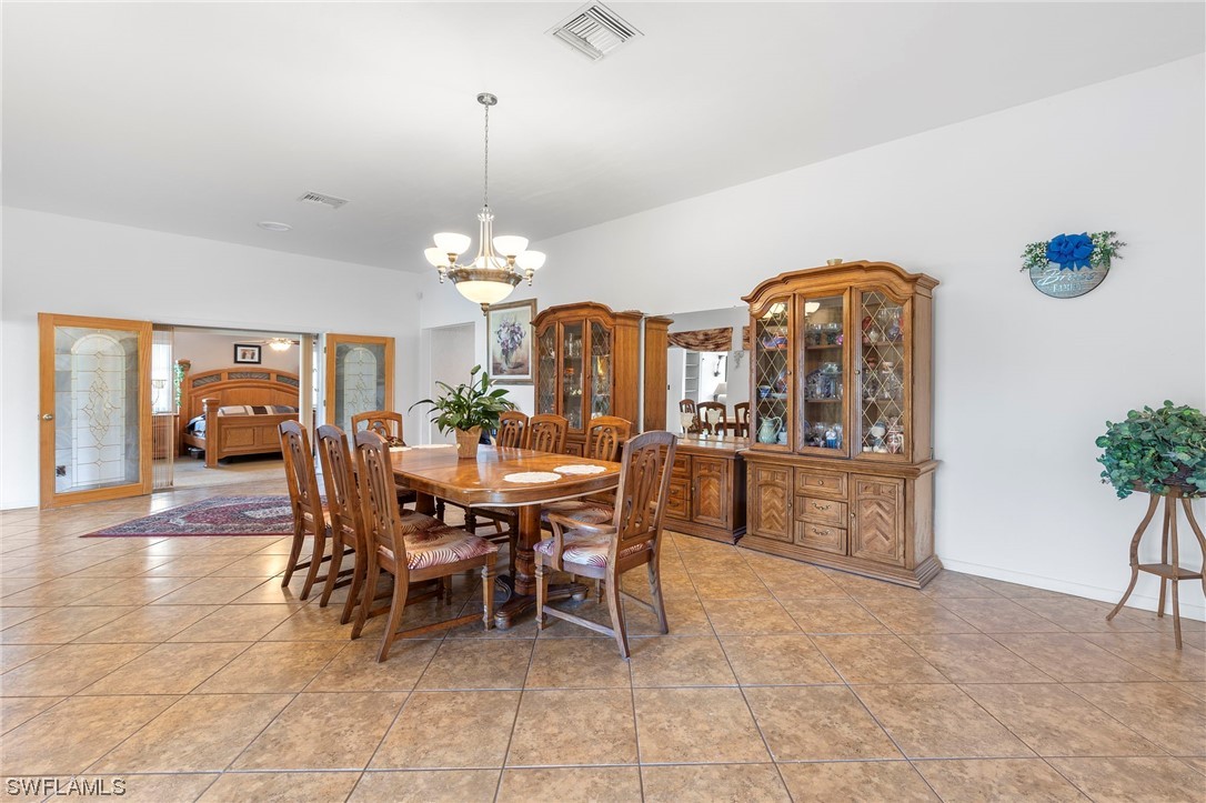 13751 River Road Fort Myers, FL 33905 - Photo 26 of 50 a view of a dining room with furniture and chandelier