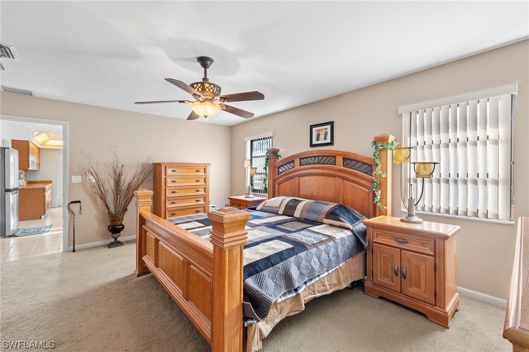 13751 River Road Fort Myers, FL 33905 - Photo 29 of 50 a bedroom with a bed and a chandelier