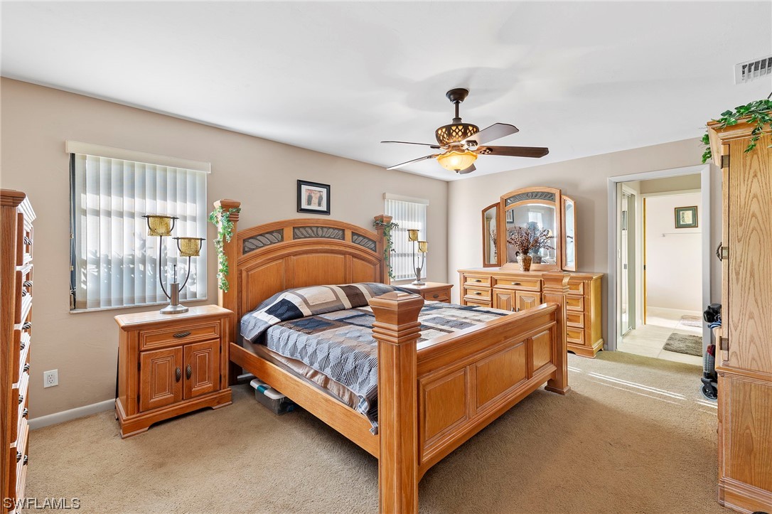 13751 River Road Fort Myers, FL 33905 - Photo 30 of 50 a bedroom with a bed and a chandelier