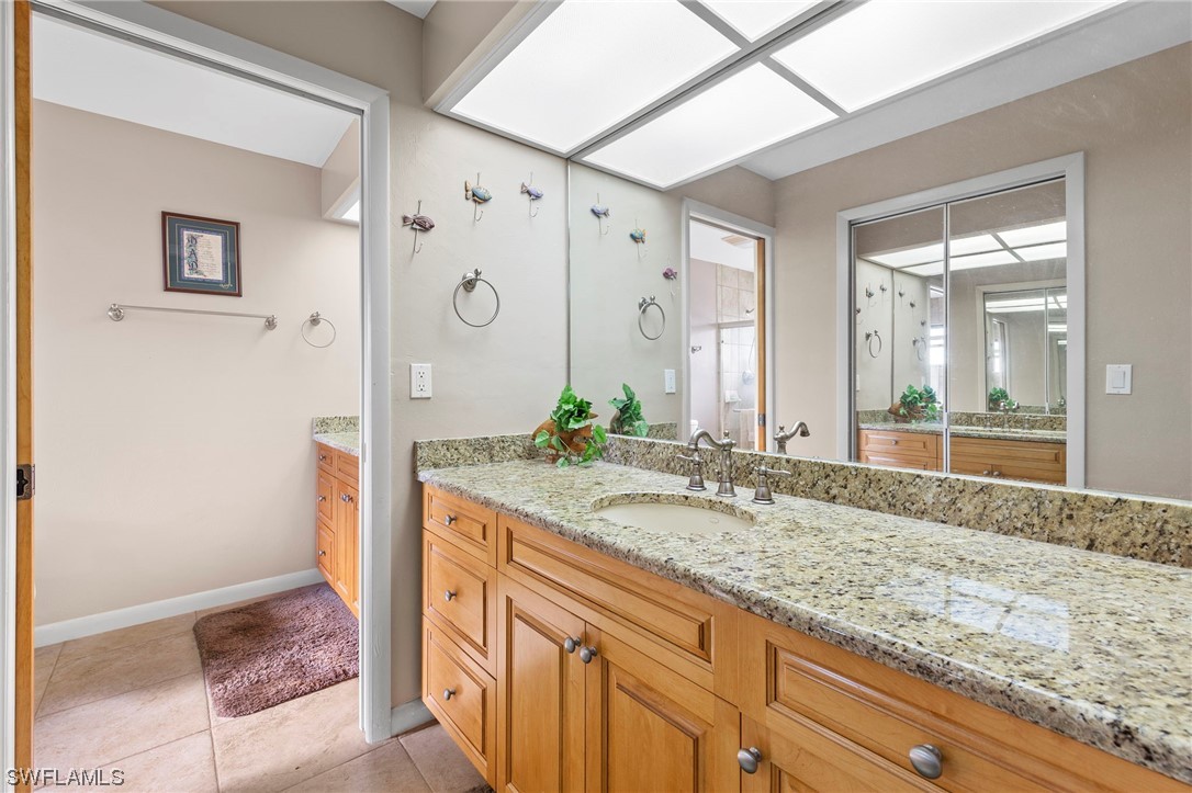 13751 River Road Fort Myers, FL 33905 - Photo 33 of 50 a bathroom with a granite countertop sink and a mirror