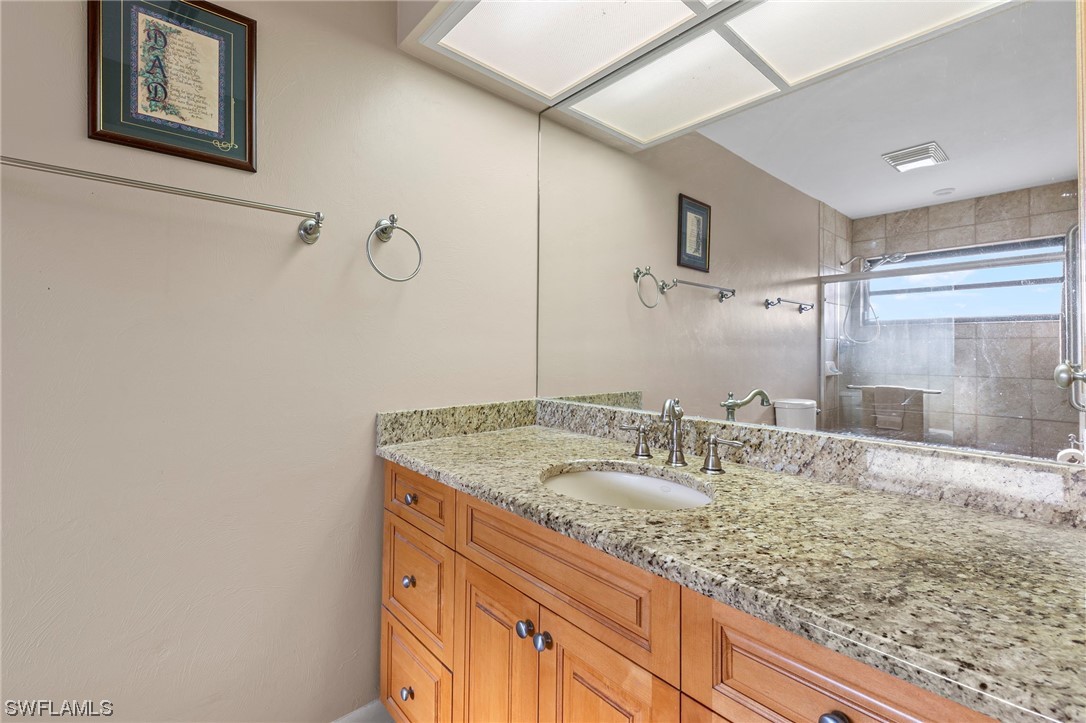 13751 River Road Fort Myers, FL 33905 - Photo 34 of 50 a bathroom with a granite countertop sink and a mirror