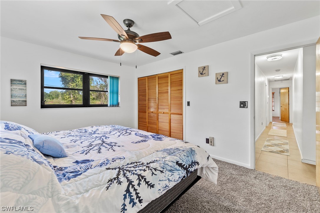 13751 River Road Fort Myers, FL 33905 - Photo 38 of 50 a bedroom with a large bed and a window