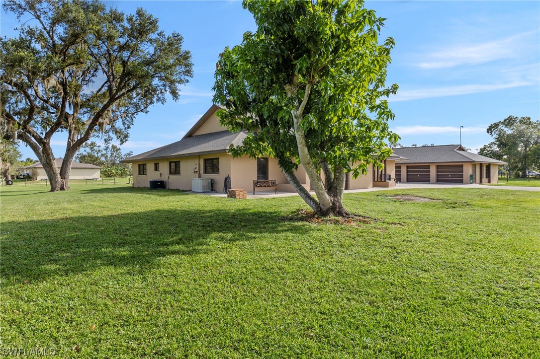13751 River Road Fort Myers, FL 33905 - Photo 46 of 50 a front view of a house with a yard
