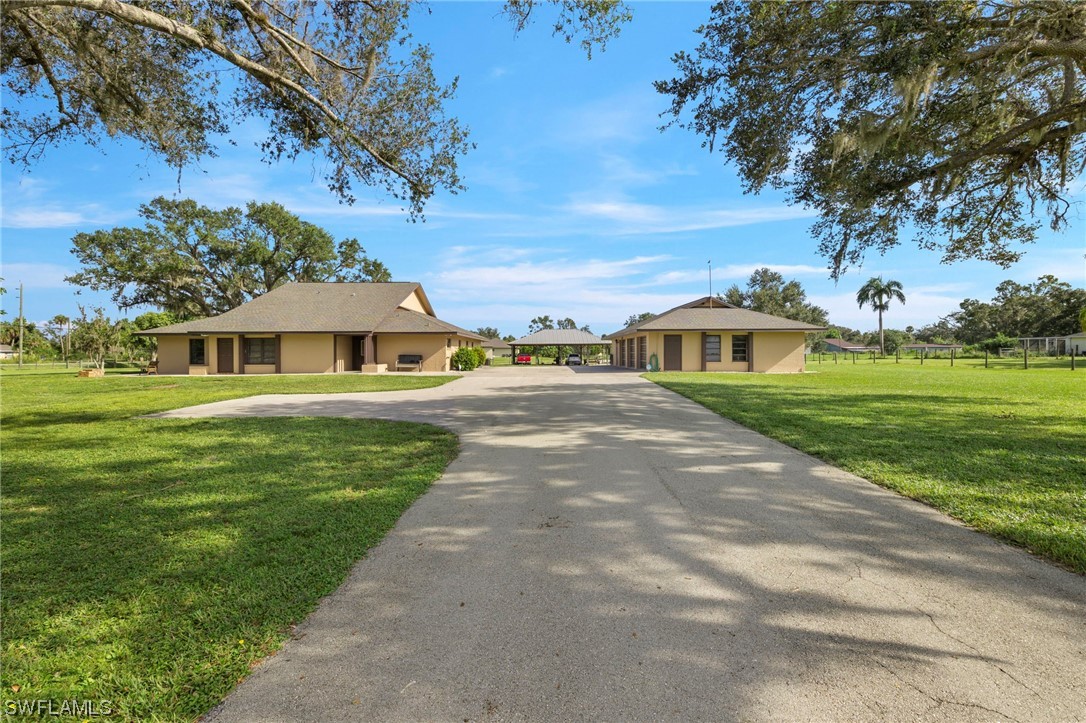13751 River Road Fort Myers, FL 33905 - Photo 47 of 50 a front view of a house with a yard