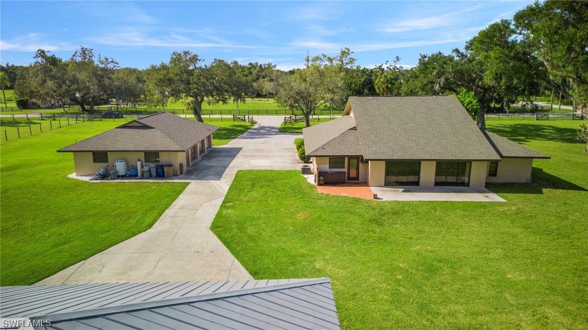 13751 River Road Fort Myers, FL 33905 - Photo 6 of 50 a aerial view of a house with swimming pool and a yard
