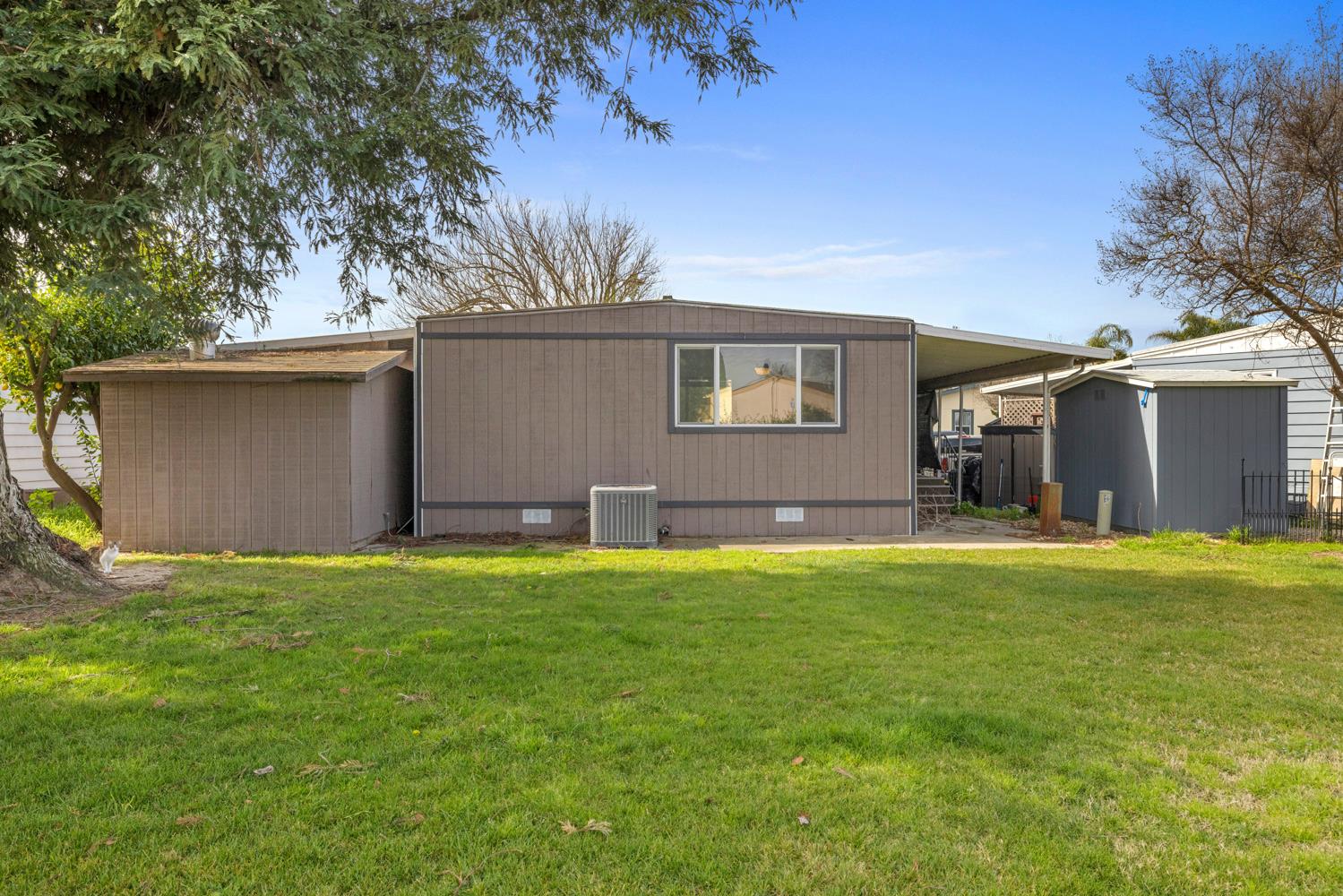 2621 Prescott Road, Unit 79 Modesto, CA 95350 - Photo 39 of 41 front view of a house with a yard and a garage