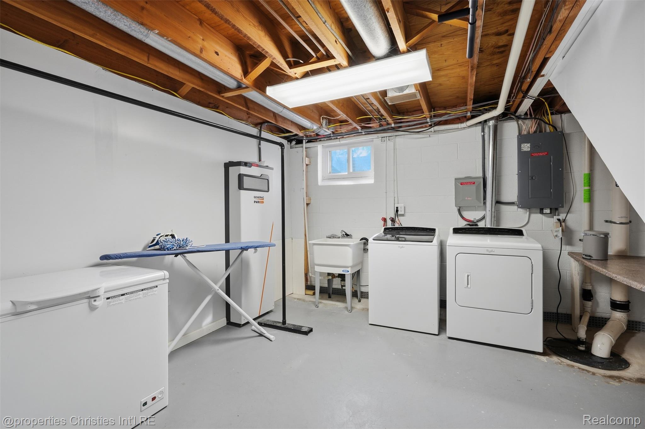 4030 Textile Road Ypsilanti, MI 48197 - Photo 37 of 58 Utility area featuring laundry appliances, exposed ceiling joists, a utility sink, and a high-efficiency water heater