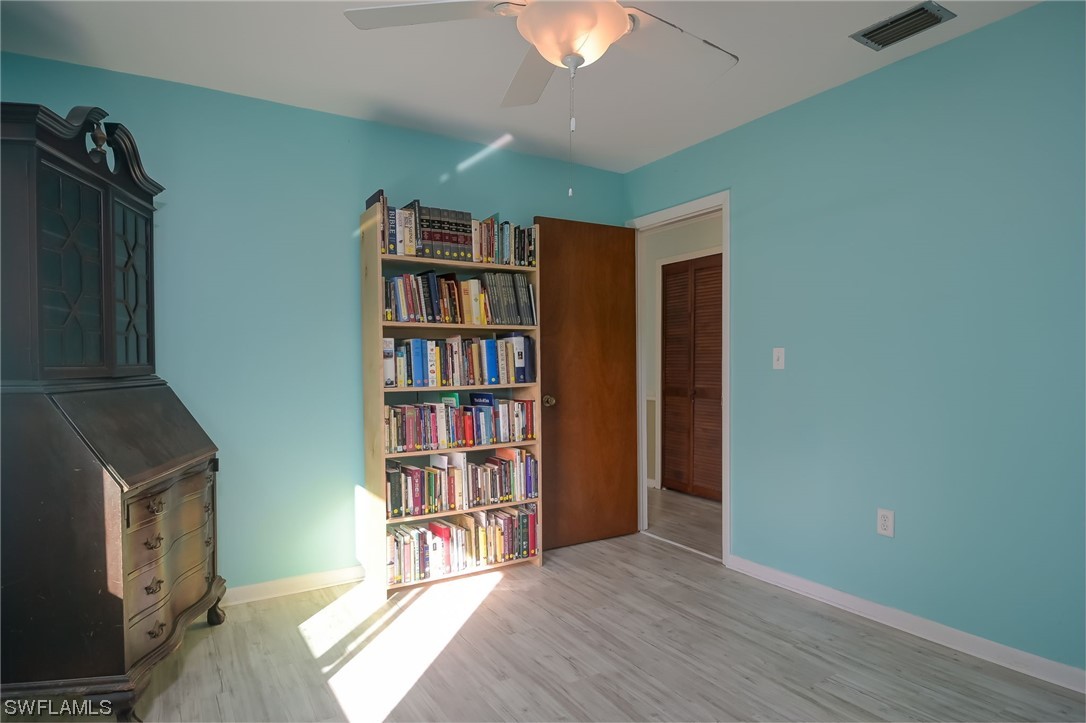 15450 Cemetery Road Fort Myers, FL 33905 - Photo 23 of 29 a living room with hard wood floors and a fireplace