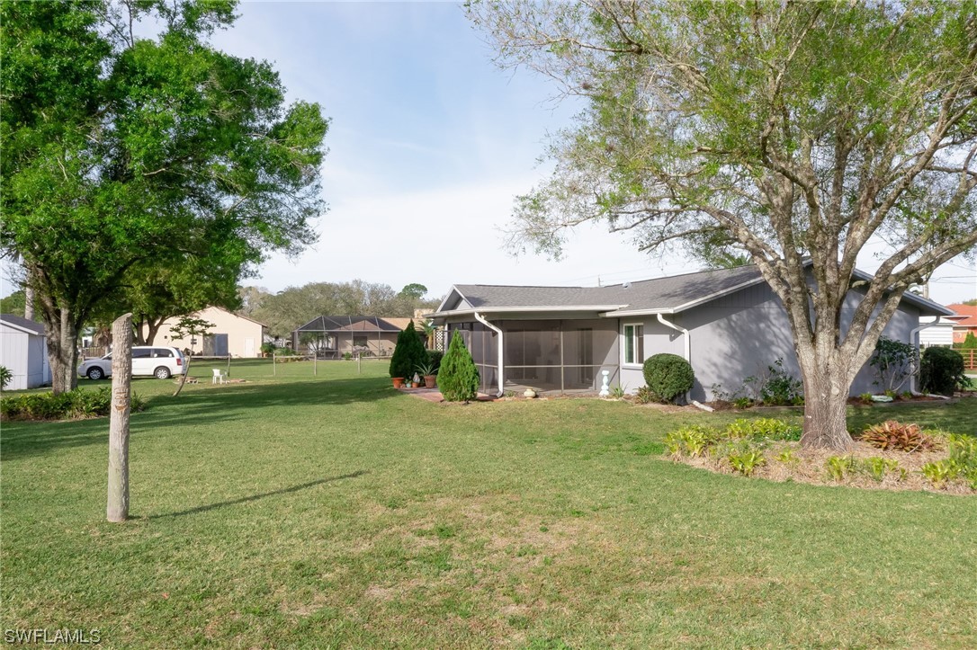 15450 Cemetery Road Fort Myers, FL 33905 - Photo 5 of 29 a view of a yard in front of a house with large trees