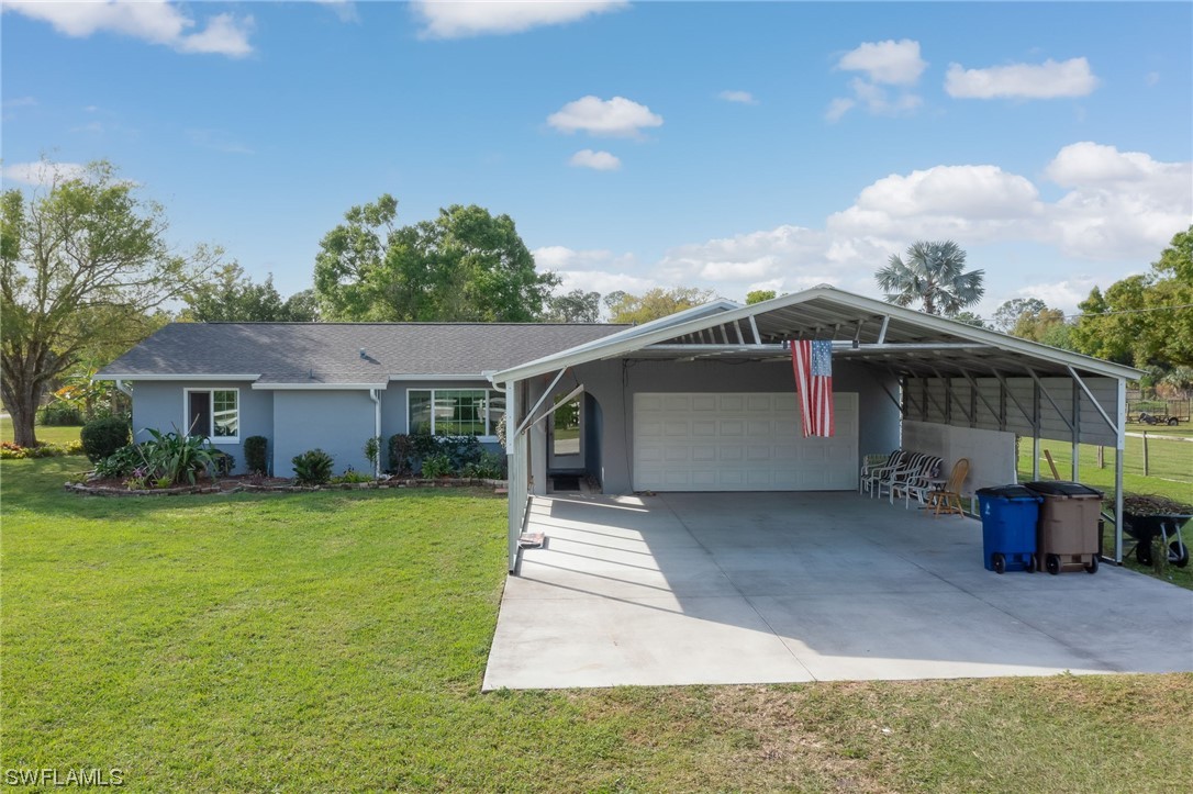 15450 Cemetery Road Fort Myers, FL 33905 - Photo 6 of 29 a front view of a house with garden