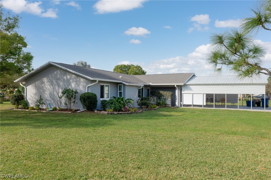15450 Cemetery Road Fort Myers, FL 33905 - Photo 7 of 29 a front view of a house with a garden