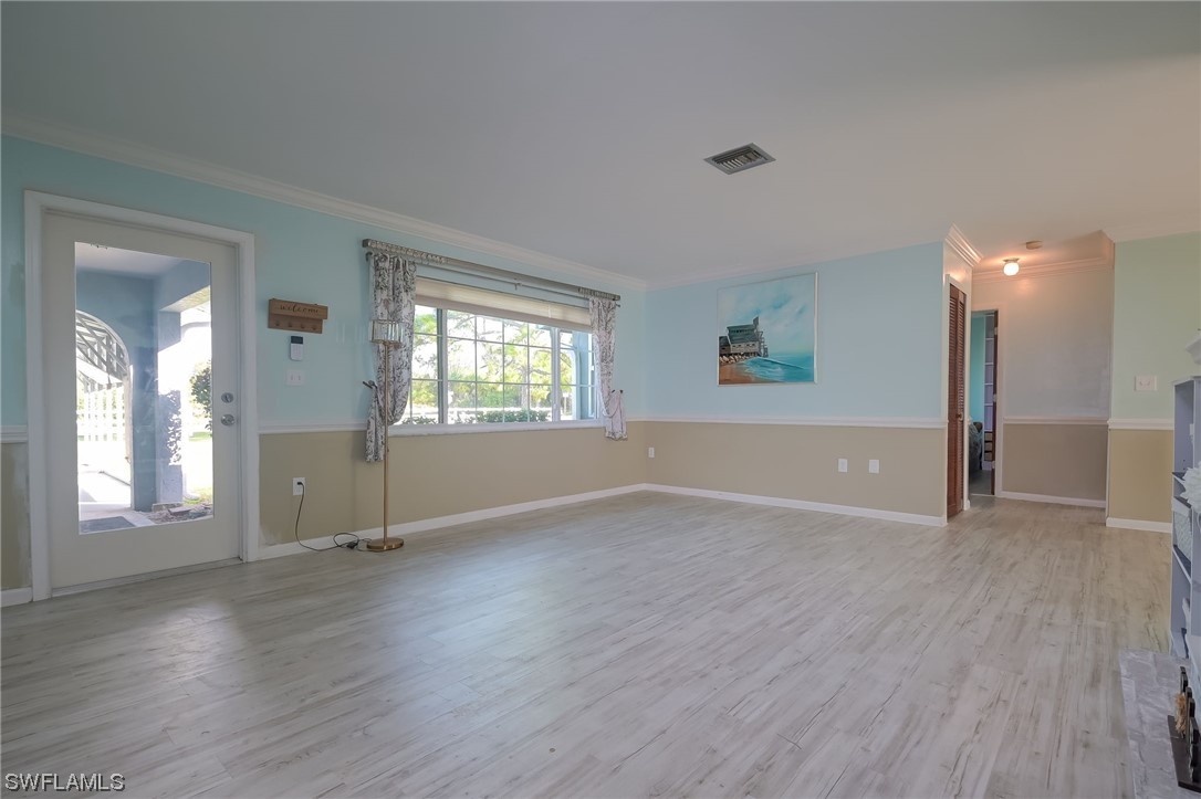 15450 Cemetery Road Fort Myers, FL 33905 - Photo 9 of 29 an empty room with wooden floor and windows