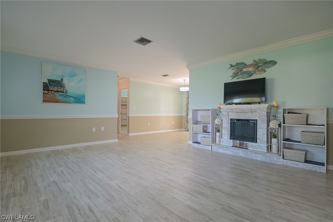 15450 Cemetery Road Fort Myers, FL 33905 - Photo 10 of 29 a view of a livingroom with a fireplace a flat screen tv and staircase