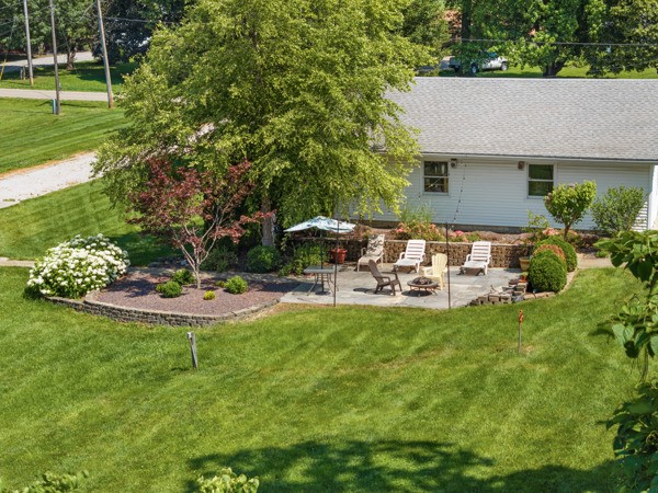 2476 East Washington Road Casey, IL 62420 - Photo 6 of 36 a view of a backyard with table and chairs potted plants and large trees