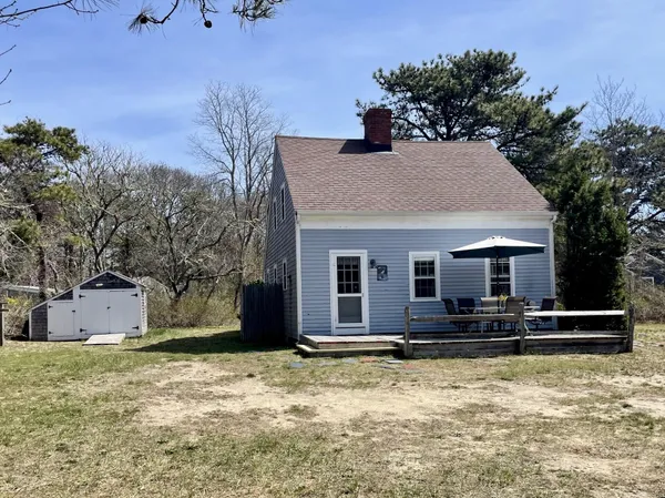 a view of a house with a yard covered in snow