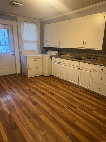 a view of a kitchen with wooden floor