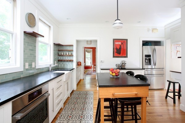 a large kitchen with a table and chairs in it